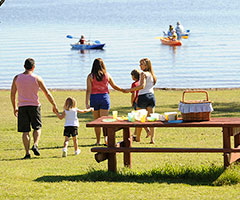 Family enjoying picnic near a lake