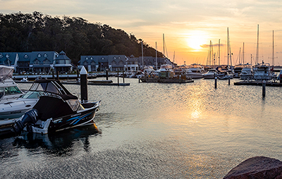 Sun setting over Anchorage Marina, Corlette in Port Stephens region. Credit: NSW Destination