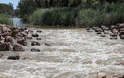 Water flowing down river bank.