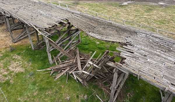 Picture of a broken wooden bridge.