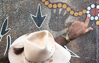 Men looking at Aboriginal artwork. Credit: Destination NSW