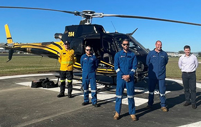 Fire trail ground crew in front of helicopter