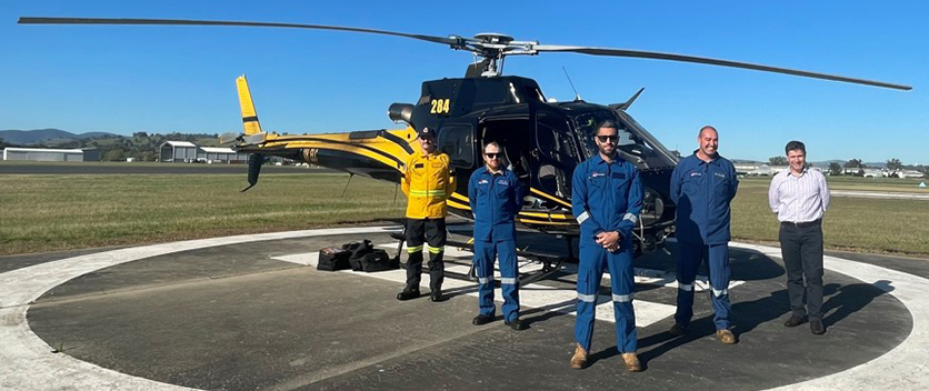 Fire trail ground crew in front of helicopter