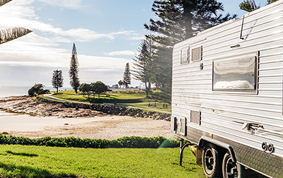 Jeep and caravan at holiday park on beach