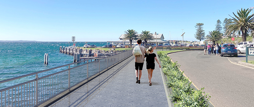 Man and woman walking on seawall path