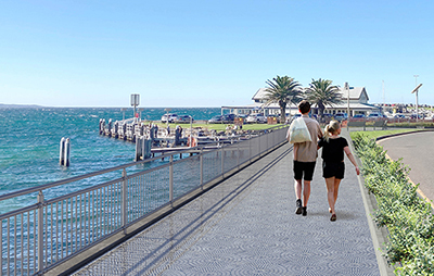 Man and woman walking on seawall path