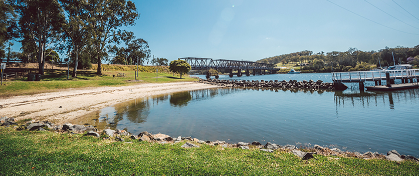 View of parklands and bridge over lake
