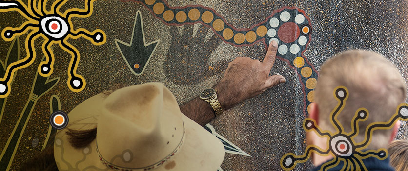Showing aboriginal artwork on cultural tour