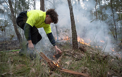 Young Aboriginal boy performing cultural burning