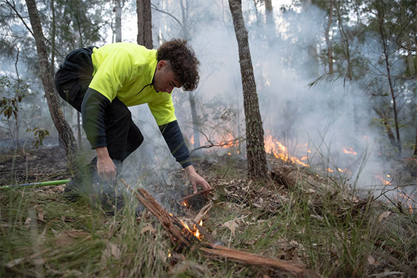 Young Aboriginal boy performing cultural burning