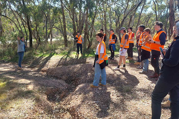 University students inspect erosion