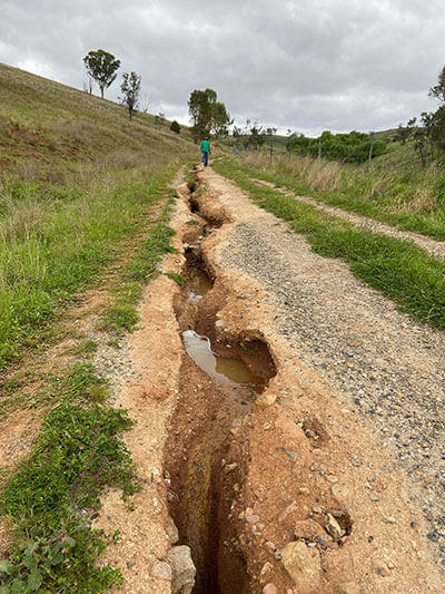 The eroded entrance road prior to its upgrade