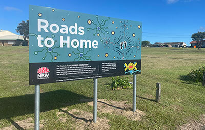 Signage 'Roads to Home' at Ngaru Village at Yamba