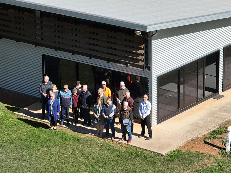 Volunteers standing in front of community building at award ceremony
