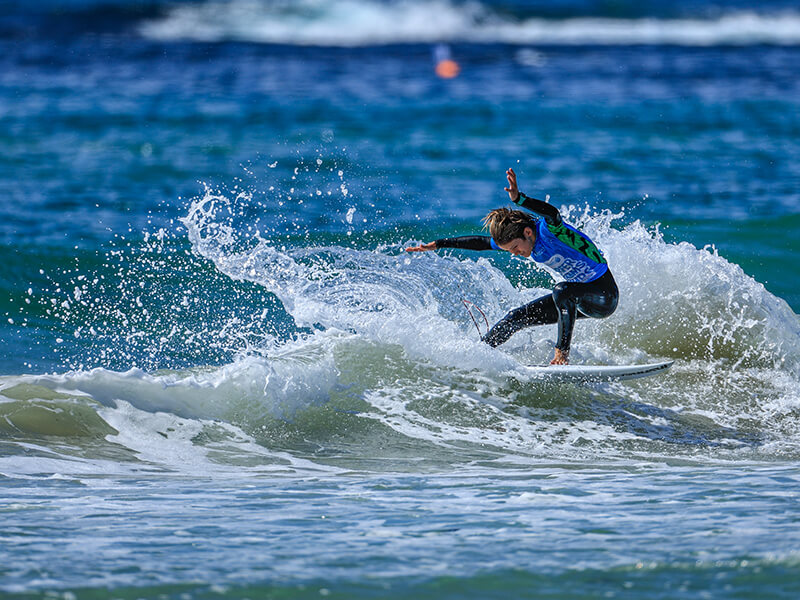 A surfer riding a wave. Credit: Lighthouse Beach Photography.