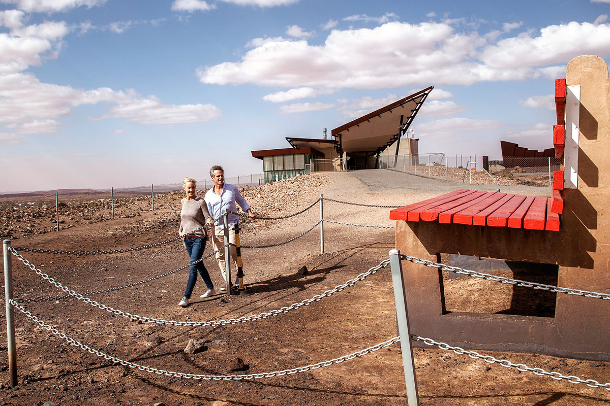 Couple viewing the Big Bench located at the Line of Lode Memorial in Broken Hill. Credit: Destination NSW