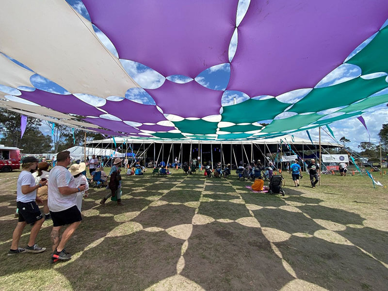 Event crowd outdoors under shade sails