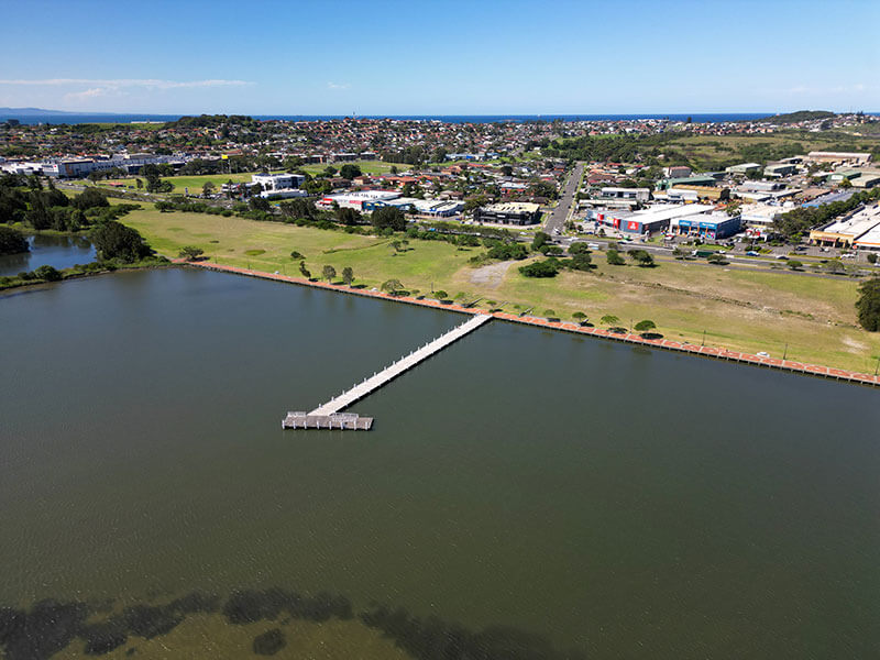 Aerial view showing the seawall at Warrawong on Lake Illawarra
