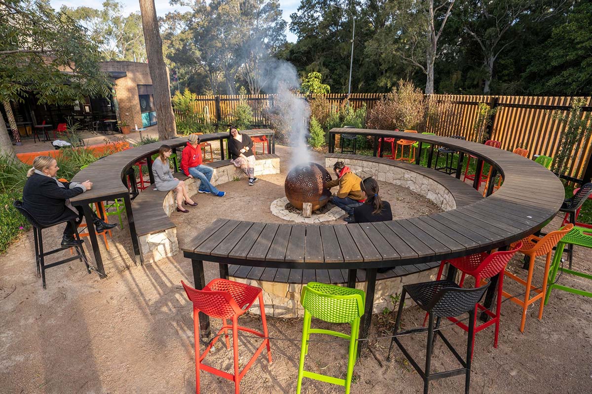 People sit at a Yarning Circle. Credit: NSW Department of Planning, Housing and Infrastructure / Dee Kramer