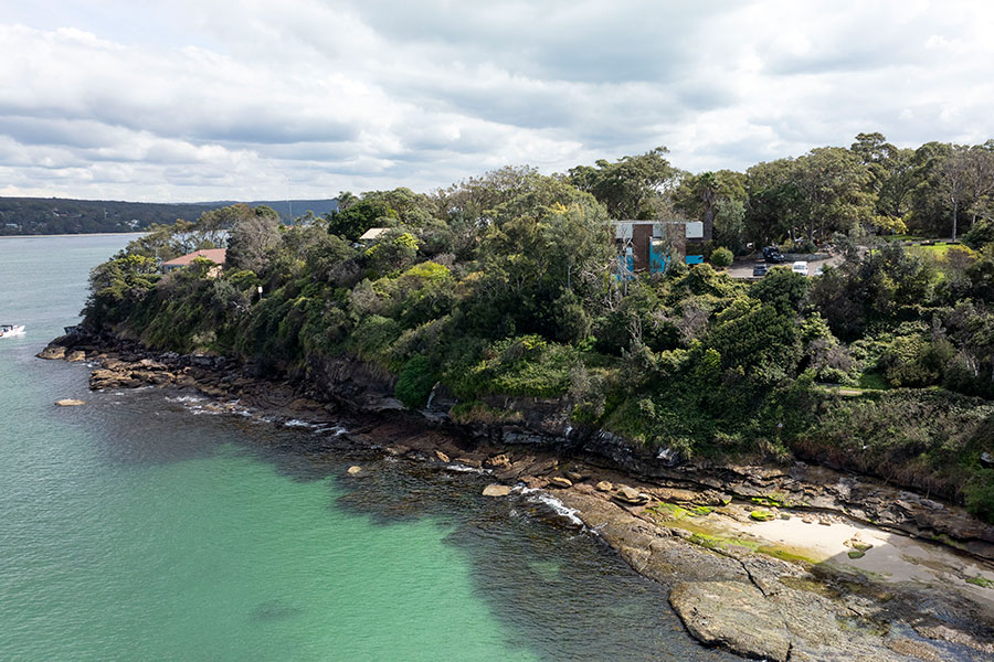 Aerial view of Hungry Point bushland on the edge of expanse of water.