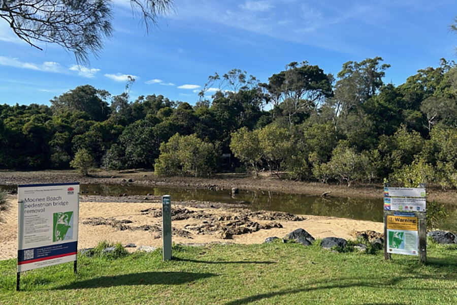 A body of water with trees in the background