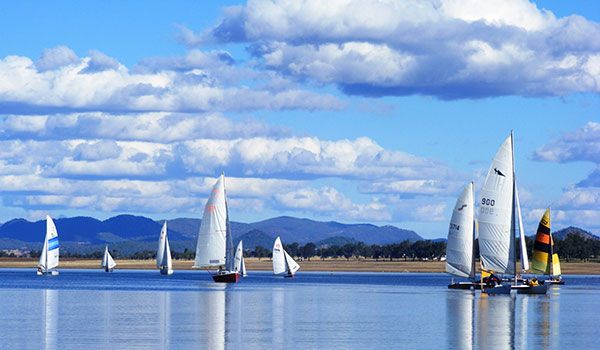 Yachts sailing on lake