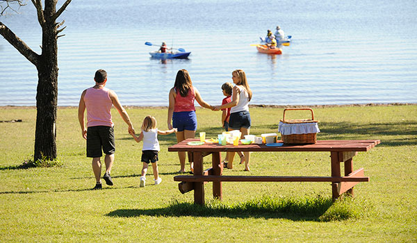 Family enjoying picnic besides lake Family enjoying picnic besides lake
