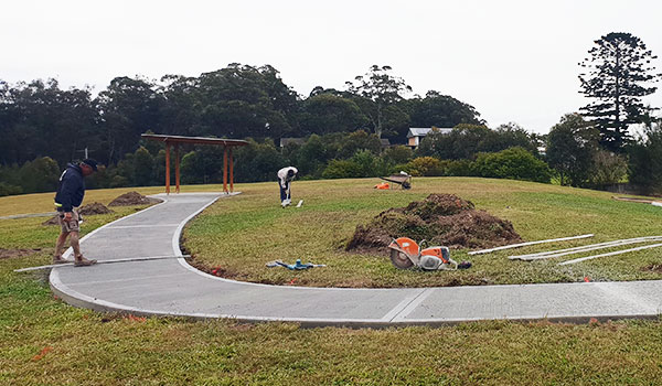 Workers completing the new concrete path leading to the picnic area