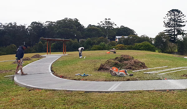Workers completing the new concrete path leading to the picnic area Workers completing the new concrete path leading to the picnic area